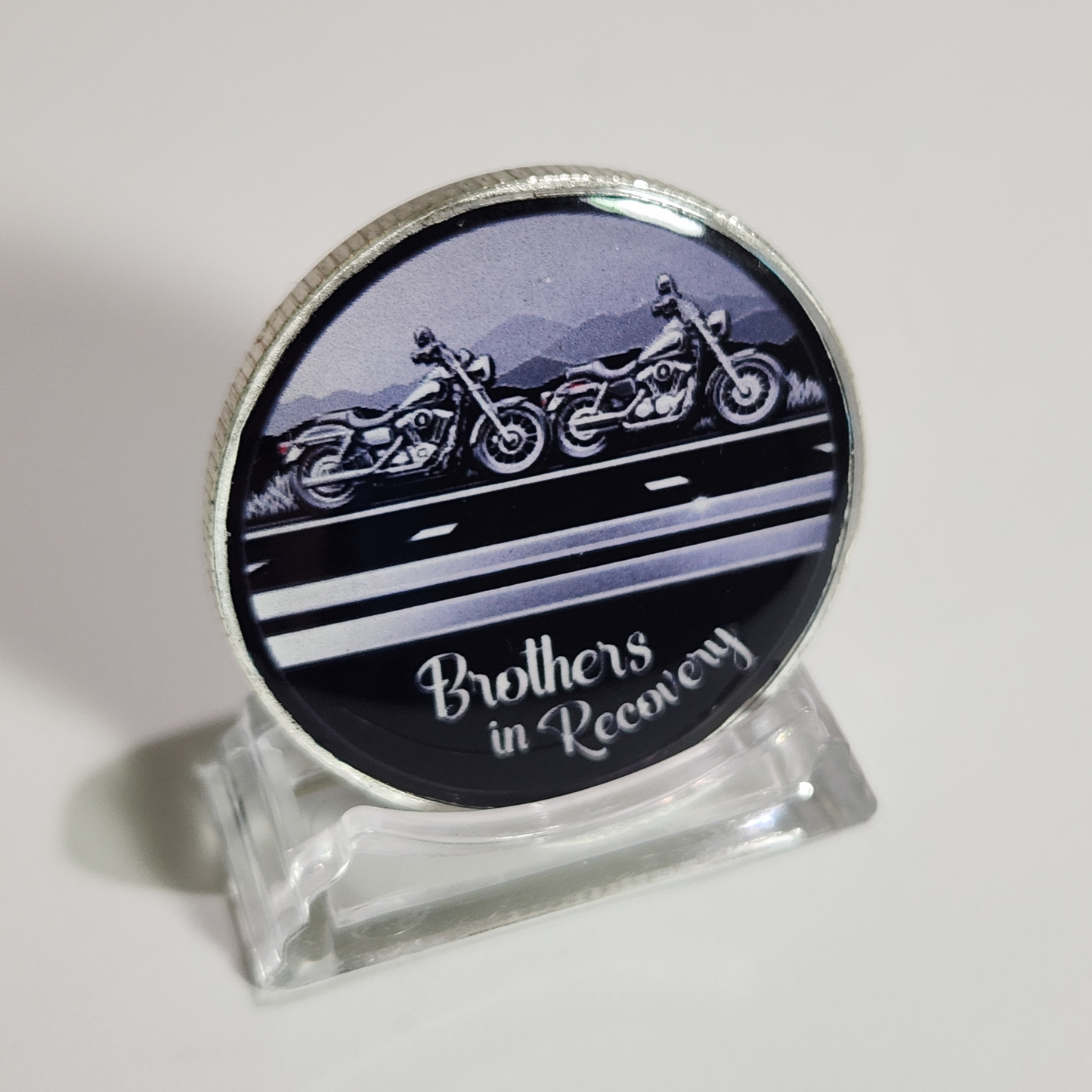 Sobriety coin with motorcycle graphic and 'Brothers in Recovery' text, clear stand