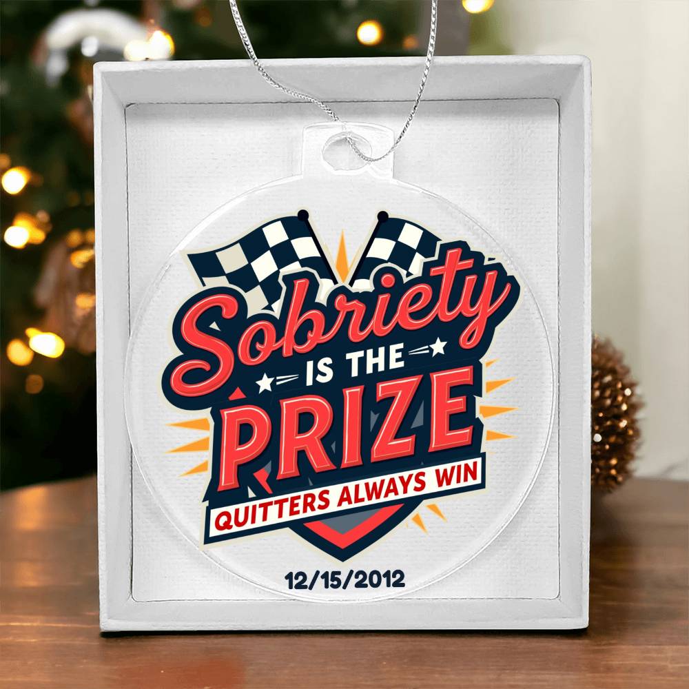 Original personalized Sobriety Is the Prize acrylic ornament with silver hanging cord in its individual gift box; example date shown.