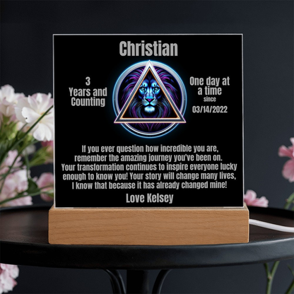 Square LED plaque with Christian triangle lion design, mounted on wood base
