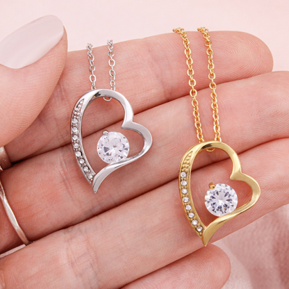 Heart pendant necklaces close-up: silver and gold tones with round center stones