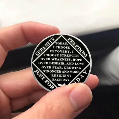 Recovery sobriety coin held in hand, Serenity Today text around circular border