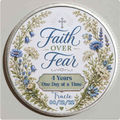 Close-up silver round recovery coin reading “Faith Over Fear” and “4 Years One Day at a Time”