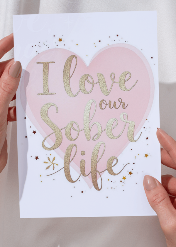 Greeting card: pink heart with glitter text "I love our sober life".