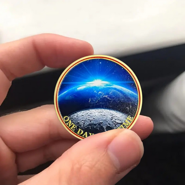 Round blue Earth prayer coin with gold border and “ONE DAY AT A TIME” text
