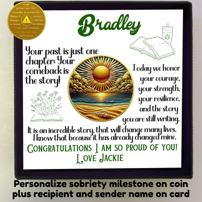 Sobriety coin in gift box with greeting card and round gold sun and ocean artwork