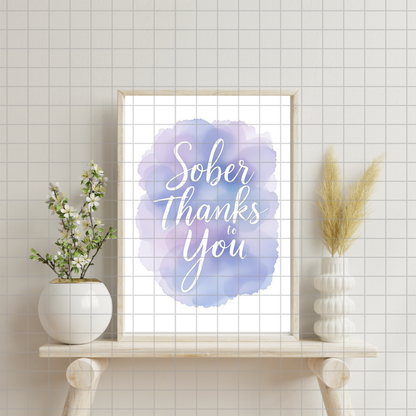 Framed wall art print with "Sober Thanks to You" script on a blue watercolor background