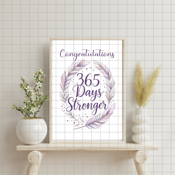 Congratulatory digital print card with “365 Days Stronger” text and purple wreath
