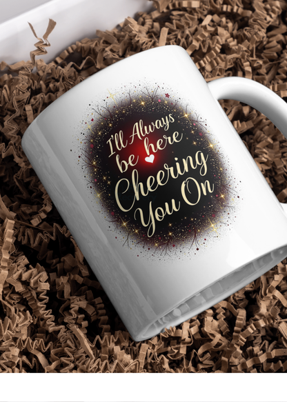 Encouragement card leaning on a white mug, gold sparkly wreath: “I’ll Always be here Cheering You On”.