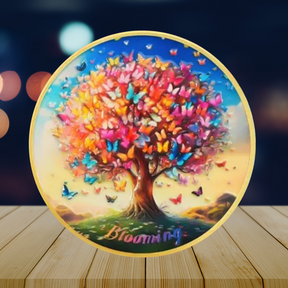 Sobriety coin on wooden surface showing butterfly tree artwork with gold border
