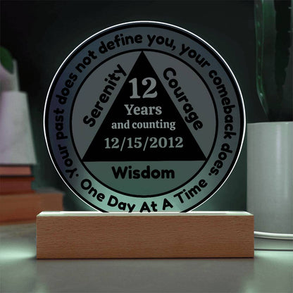 Circular LED sobriety date plaque with wooden base; glow around edges, reads 12 Years Wisdom