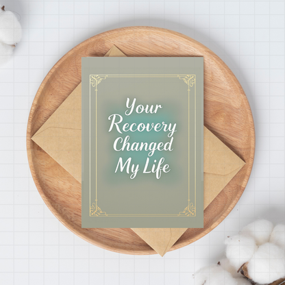 Your Recovery Changed My Life sponsor card with gold frame on kraft envelope
