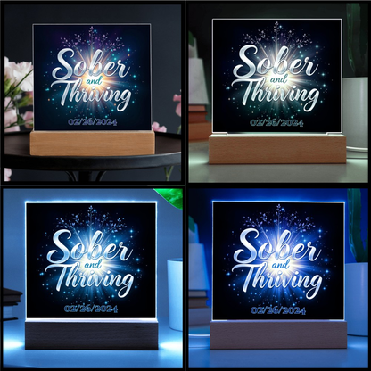 LED acrylic plaque with 'Sober and Thriving' and date on wood base, multi-color glow