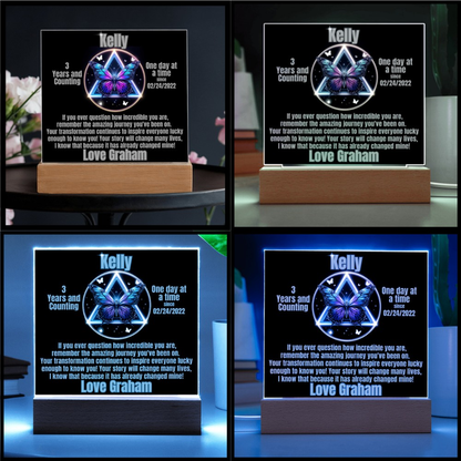 Personalized LED milestone plaque with blue glowing butterfly emblem on wooden base