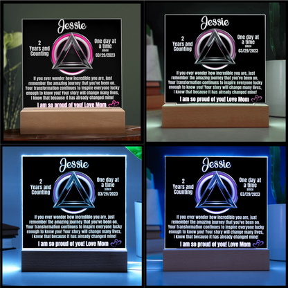 Personalized LED sobriety milestone plaque shown in multiple glowing colors on wooden base