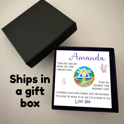 Gift box open showing personalized card with beach recovery coin and butterfly