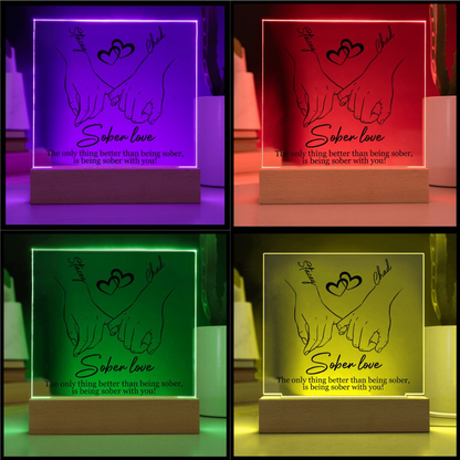 Sober love LED plaque with hands-and-heart design, wood base, shown in multiple LED colors