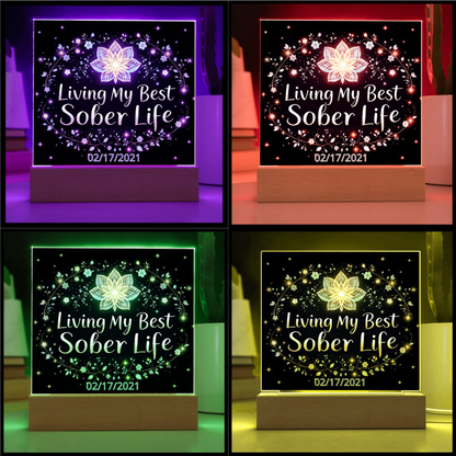 LED acrylic plaque on wooden base with multicolor lit floral “Living My Best Sober Life”