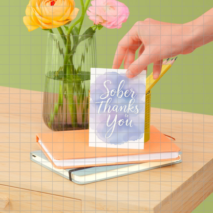Printed card design with "Sober Thanks to You" script on a blue watercolor circle