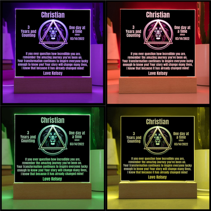 Square LED plaque on wood base showing Christian triangle lion design with message