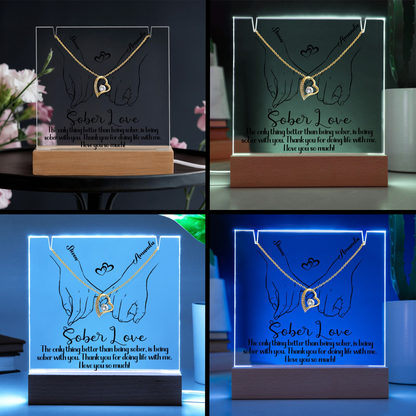 LED base with illuminated hands and heart pendant graphic on a wooden stand