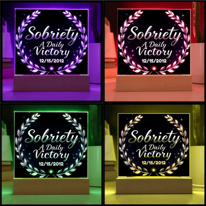 Square LED plaque on wood base with purple laurel wreath in multi-color LED glow.