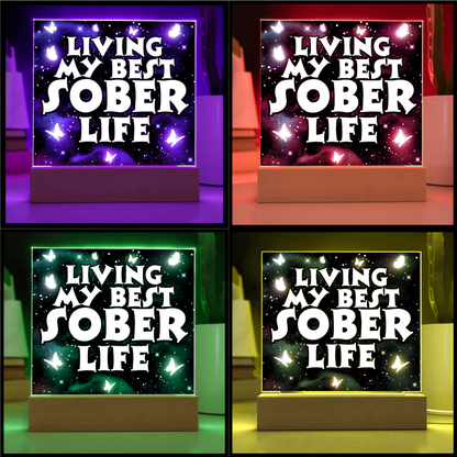 Glowing square LED acrylic plaque color variants on wood base, "Living My Best Sober Life".