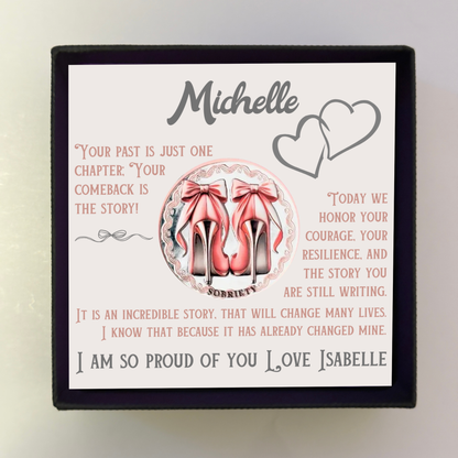 Sobriety coin keepsake card with pink bow heels and 'I am so proud of you' text