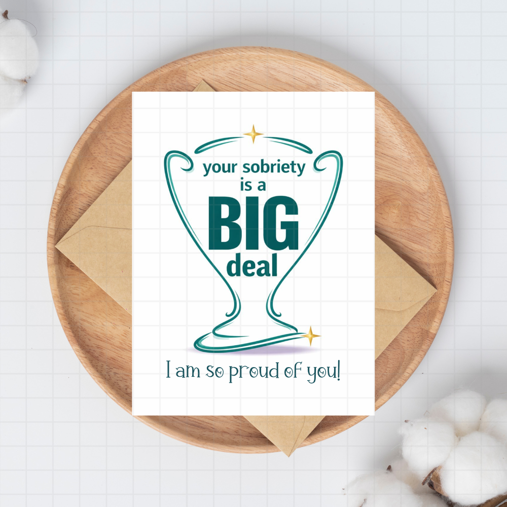 Sobriety encouragement card with teal 'Big deal' heart, on kraft envelope.