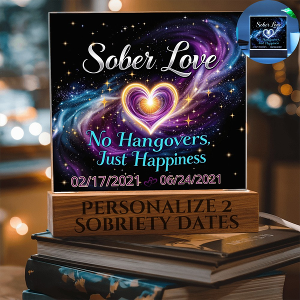 LED sobriety date sign with glowing heart on wood base atop book stack