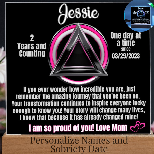 Personalized LED sobriety milestone plaque close-up with pink ring triangle motif on base