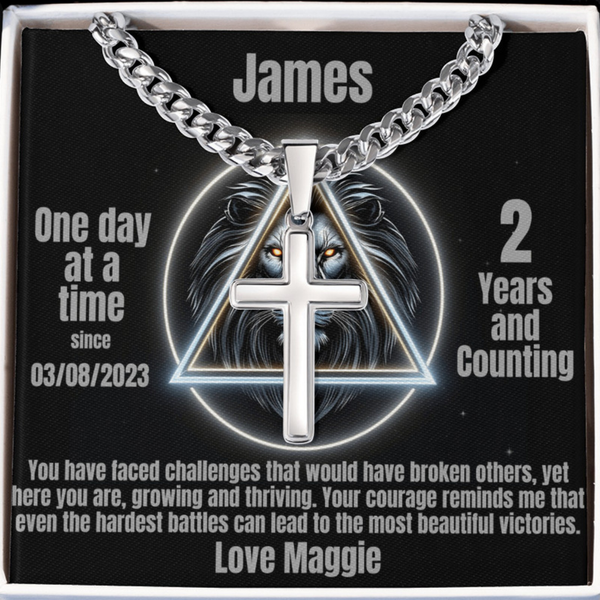 Silver-tone cross pendant necklace on black card with James name