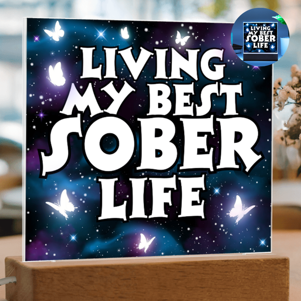 Square LED acrylic plaque on wood base, glowing "Living My Best Sober Life".