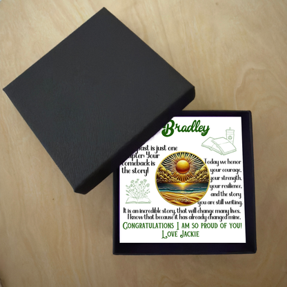 Sobriety coin gift box with black lid and card showing sun and ocean design