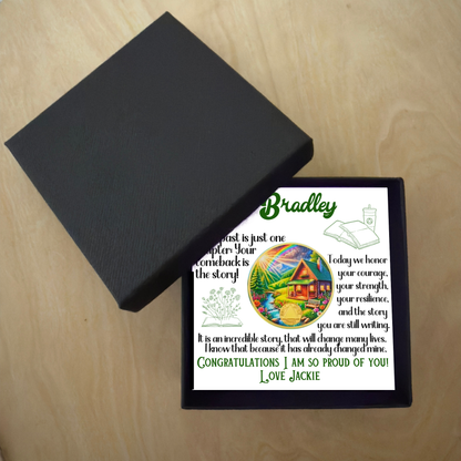 Bradley gift box with card and circular sobriety milestone coin beside open lid