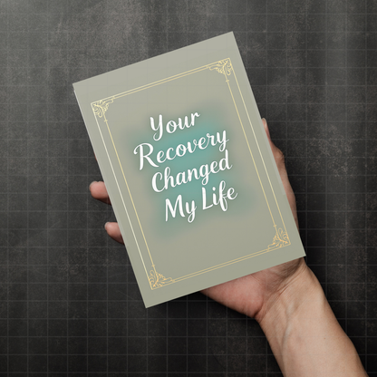 Your Recovery Changed My Life sponsor card held in hand, gold frame on green-blue background