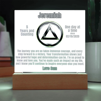 Personalized LED plaque with circular emblem and wooden base, softly lit panel