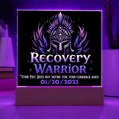 LED acrylic plaque with warrior emblem and “Recovery Warrior” on wood base, purple glow