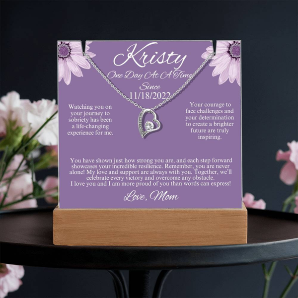 LED acrylic plaque with Kristy text and heart charm pendant, floral corners on wooden stand