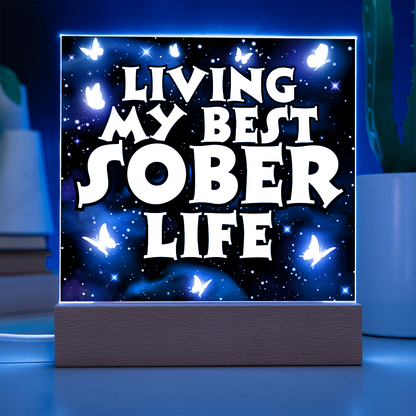 Square LED acrylic plaque with white border, glowing "Living My Best Sober Life".