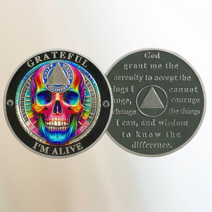 Rainbow skull sobriety coin, round black design with colorful skull and “I’m Alive” text
