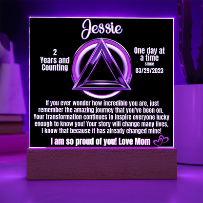 Personalized LED sobriety milestone plaque with purple glow triangle motif on wooden base