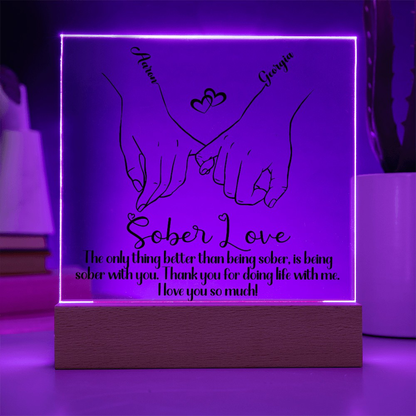 LED sobriety plaque with hands-heart design and message, purple glowing frame, wood base