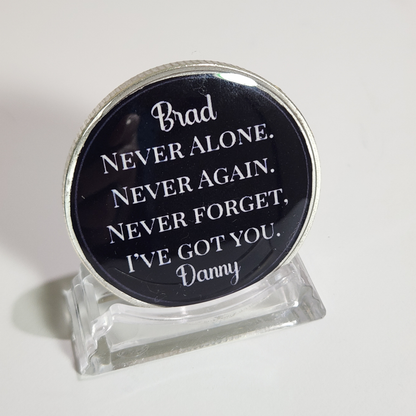 Sobriety coin with 'Brad' name and motivational quote, clear stand