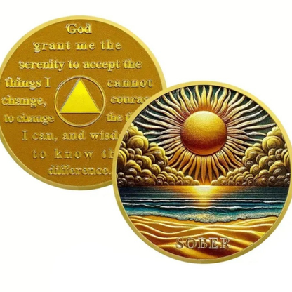 Overlapping gold sobriety coins with sunrise ocean scene and scripture text