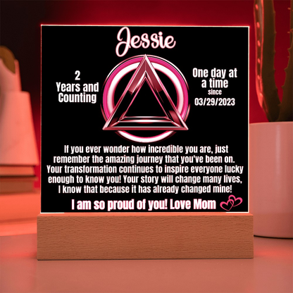 Personalized LED sobriety milestone plaque with red glow triangle motif on wooden base