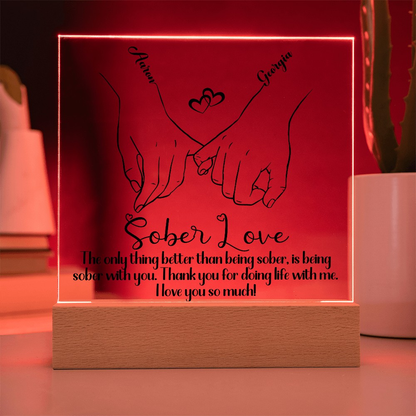 LED sobriety plaque with hands-heart design and message, red glowing frame, wood base