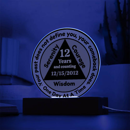 Circular LED sobriety date plaque on wooden base; reads 12 Years and Wisdom