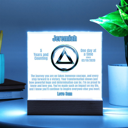Personalized LED plaque with circular emblem and wooden base, cool green-lit glowing panel