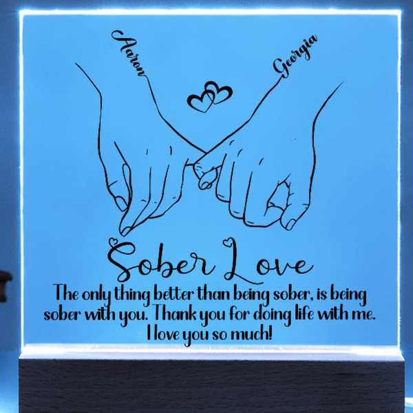 LED sobriety plaque with hands-heart design and message, blue glowing frame, wood base