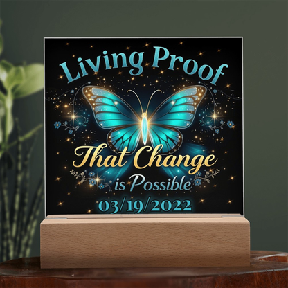 LED acrylic plaque with teal butterfly glow and 'Living Proof That Change is Possible 03/19/2022'